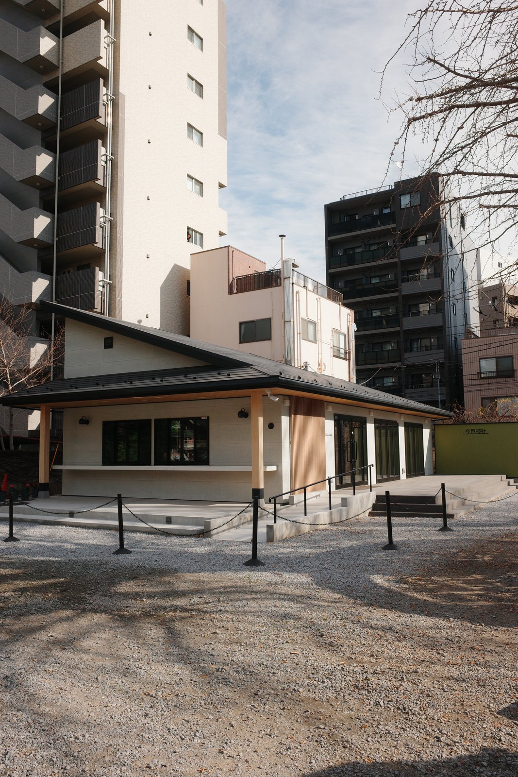 modern wooden pavilion in a gravel yard