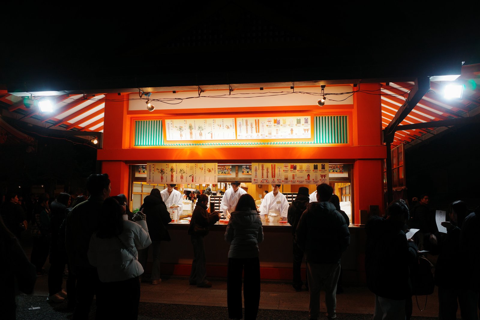 lit shrine kiosk at fushimi inari at night