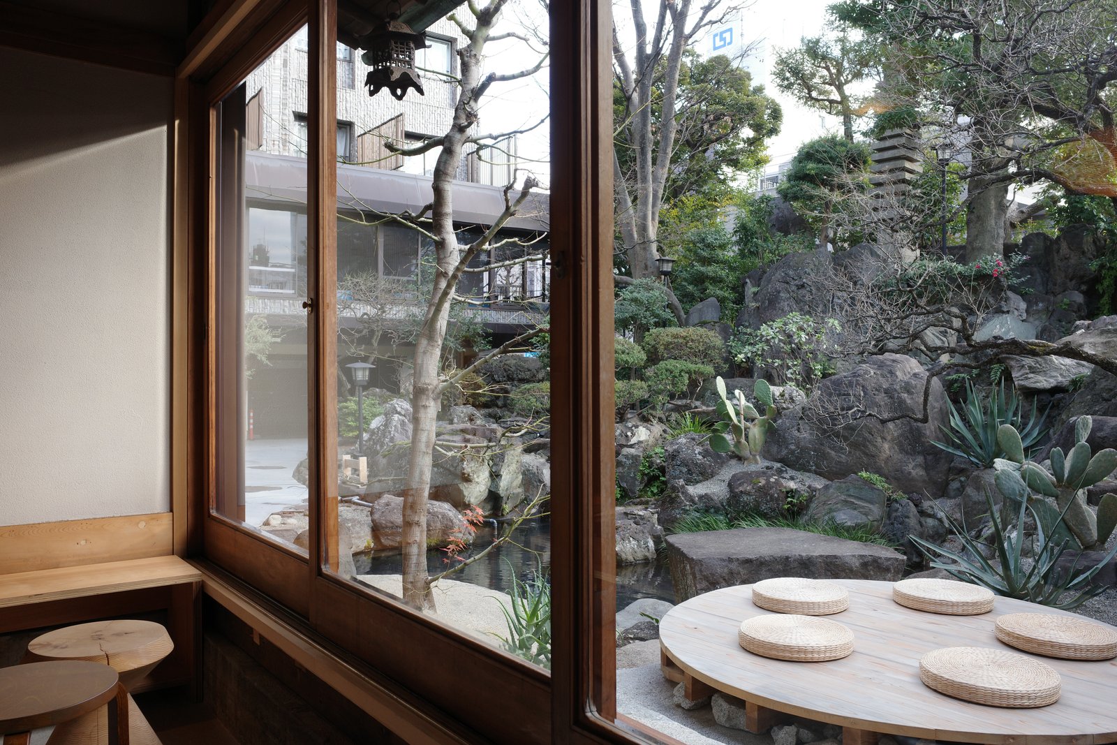 round table by a window onto a rock garden