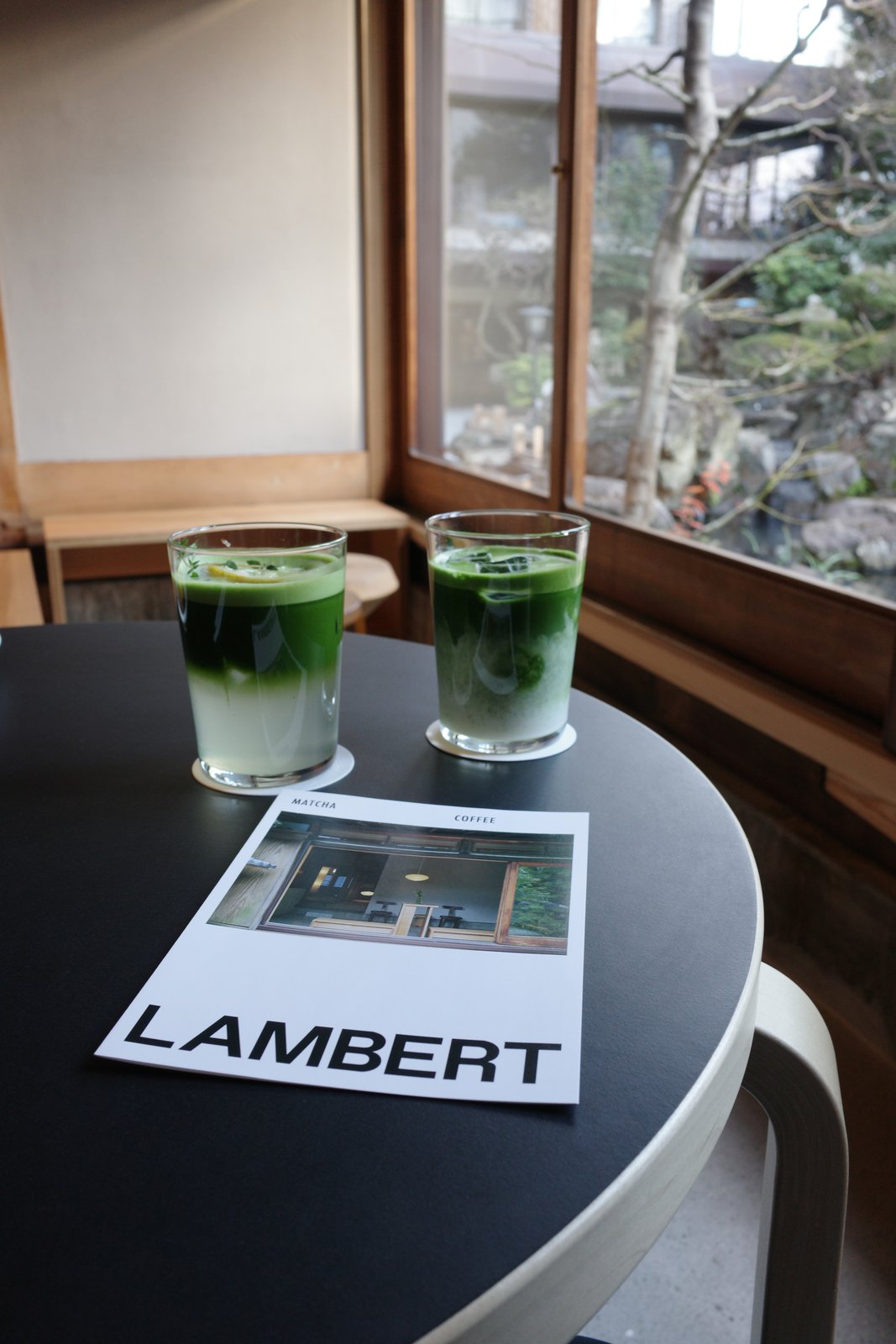 two matcha lattes on a café table