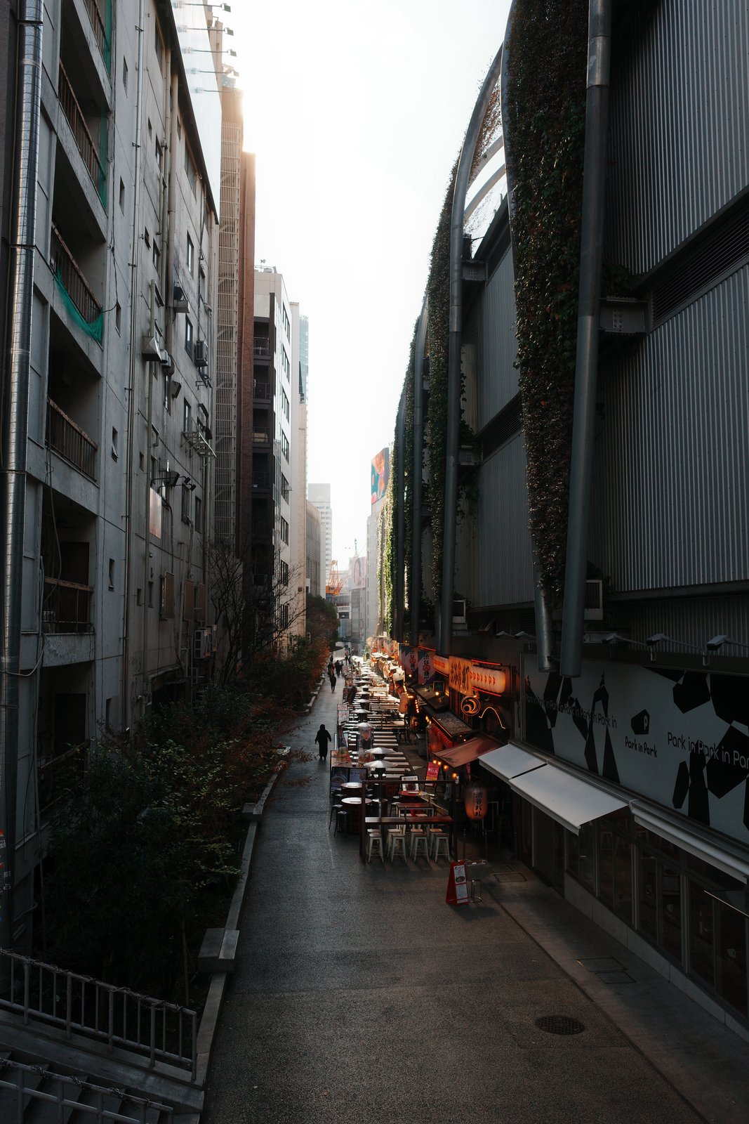 row of café tables in a narrow alley at dawn