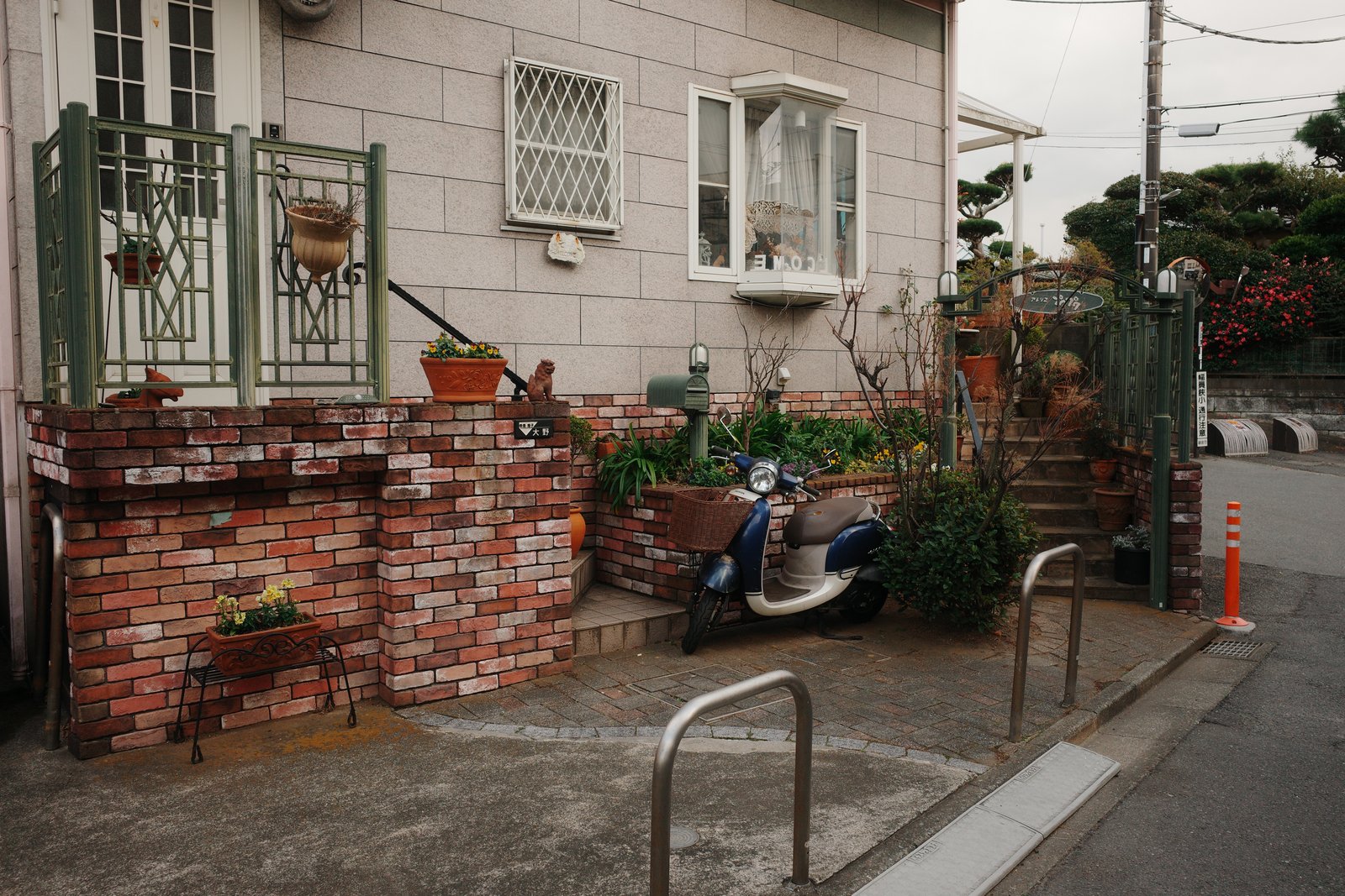 brick-walled house corner with a scooter