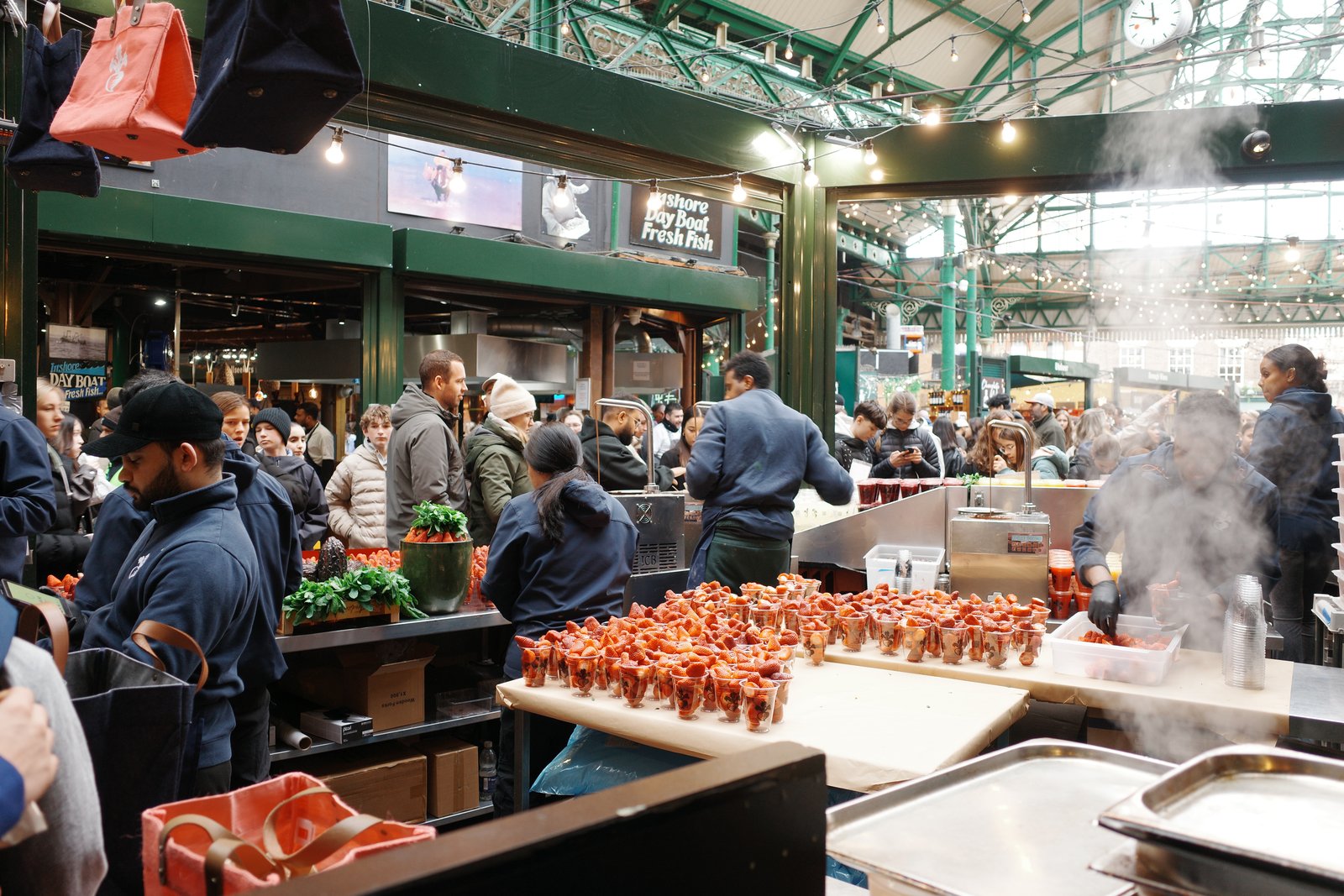 crowds at borough market under iron arches